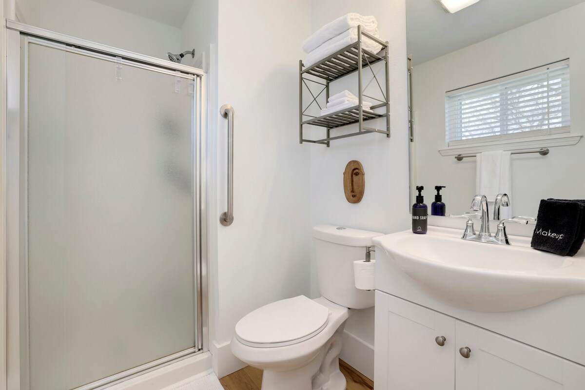 This en suite bathroom has a single sink, shower and plenty of storage.