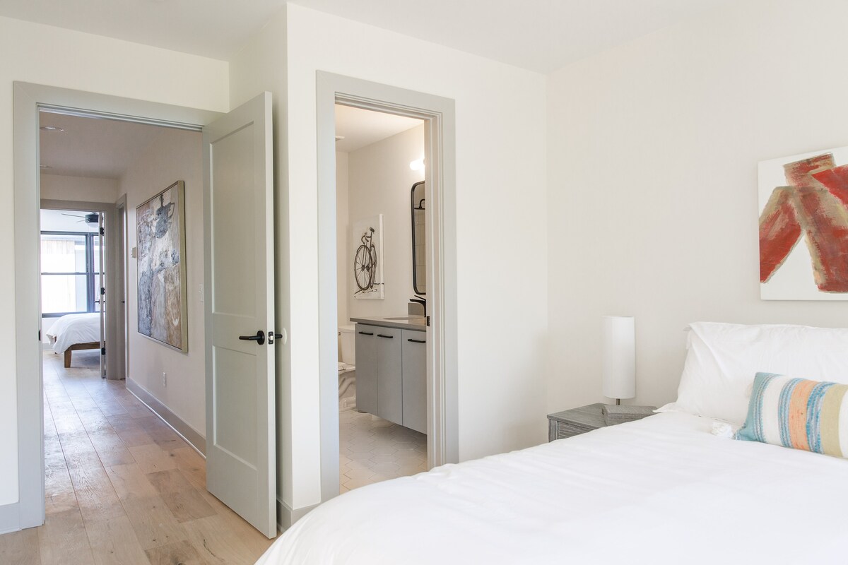 The Master bathroom can be accessed through a door to the left of the bed.