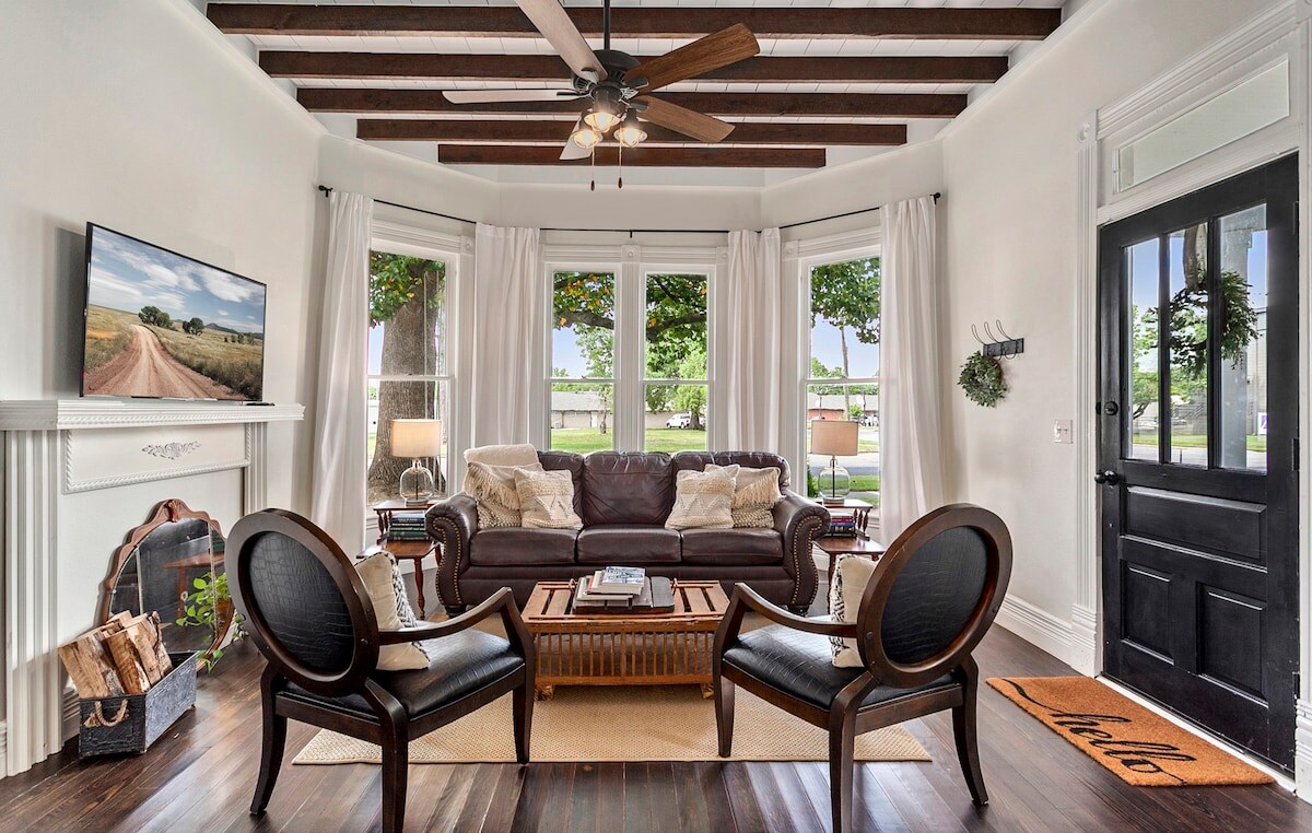 Living room features bay window and original beamed ceiling.