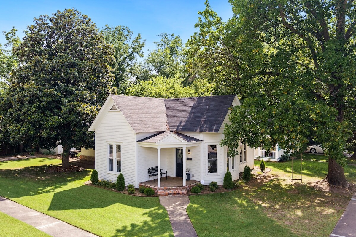 Welcome to The Grove Cottage! Established 1897. Reestablished 2019. The cottage is situated on a corner lot and has a front porch.