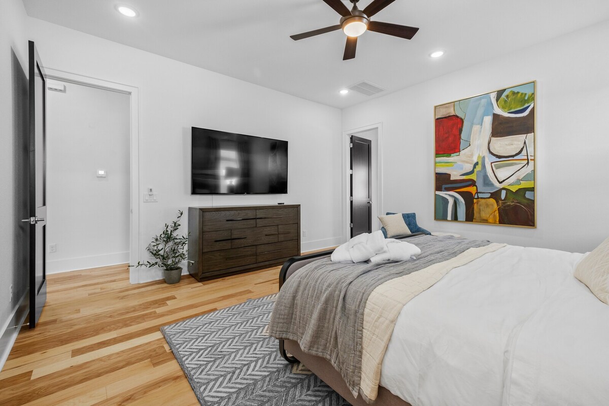 Our Master Suite features a plush King-size bed, Roku TV, dresser, walk-in closet, blackout curtains and en suite bathroom.