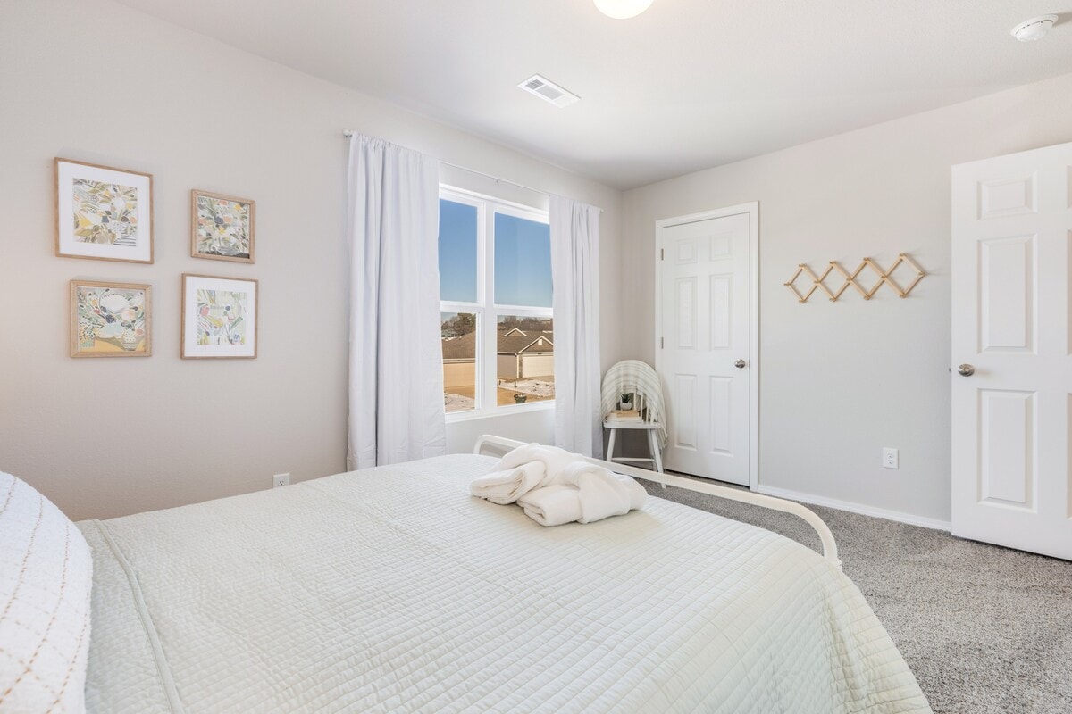Our third Queen bedroom features a closet, fresh mint green linens and nearby bath