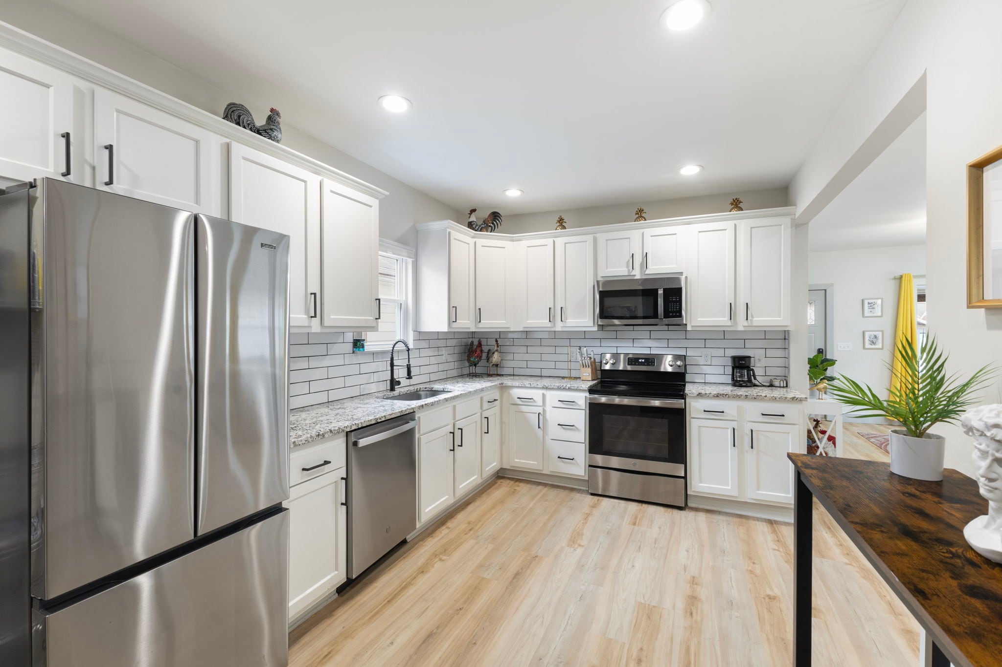 Top-of-the-line appliances include an electric range & a french door fridge