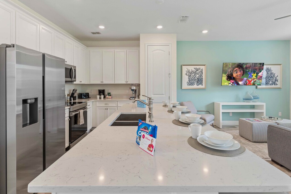 Stylish kitchen of the cottage in Kissimmee Florida - Well-lit workspace with strategically placed task lighting - Integrated appliances for a seamless and stylish appearance