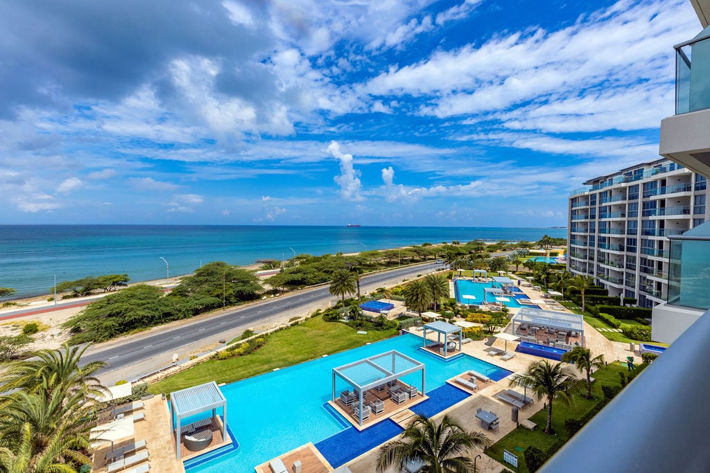 This beachfront property offers stunning ocean views, sparkling pools, and lush tropical gardens perfect for relaxation. Nearby beach access and modern amenities create an idyllic coastal escape.