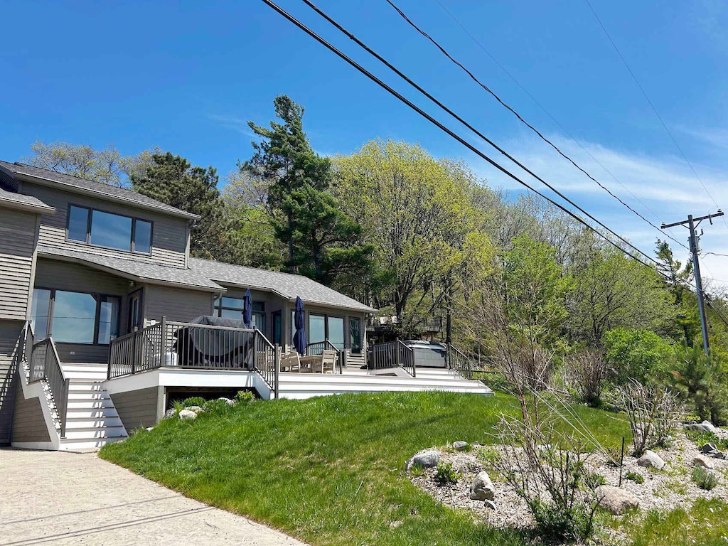 Spacious deck with outdoor dining and grill, perfect for relaxing or entertaining.