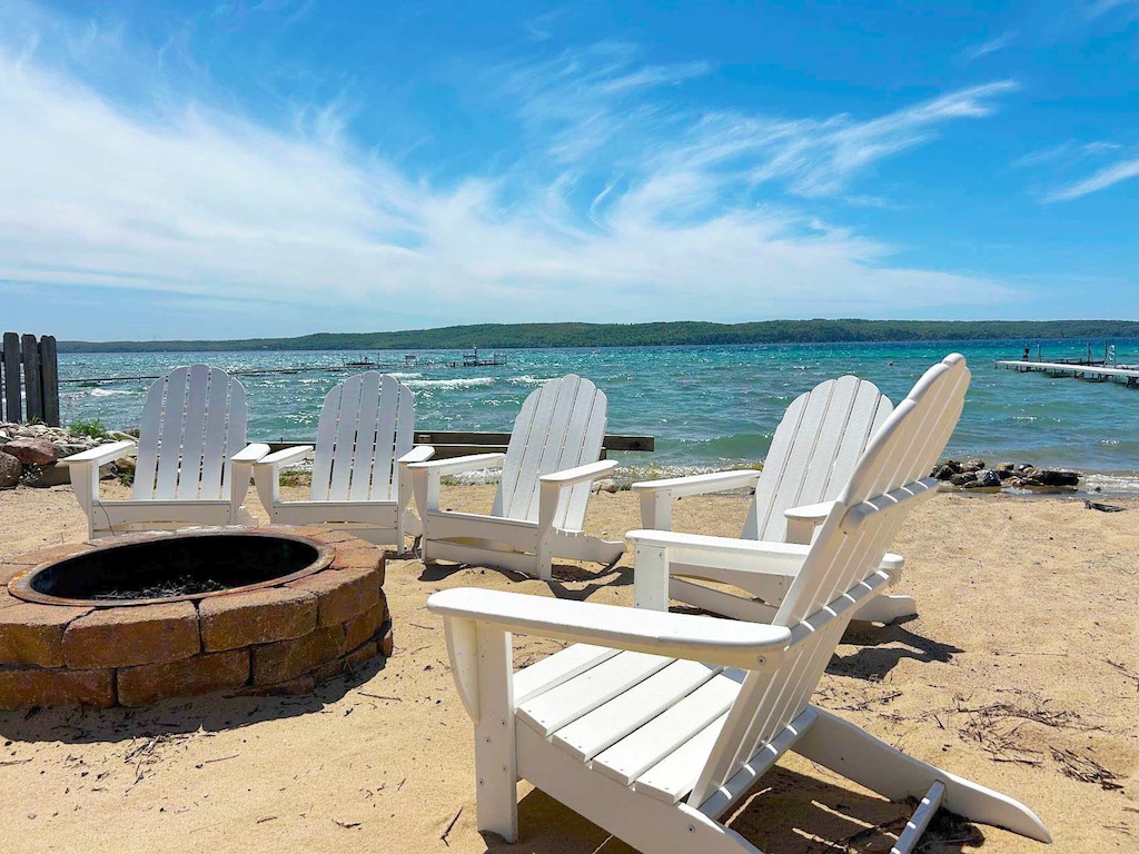 Beachfront fire pit and seating, ideal for evenings by the water.
