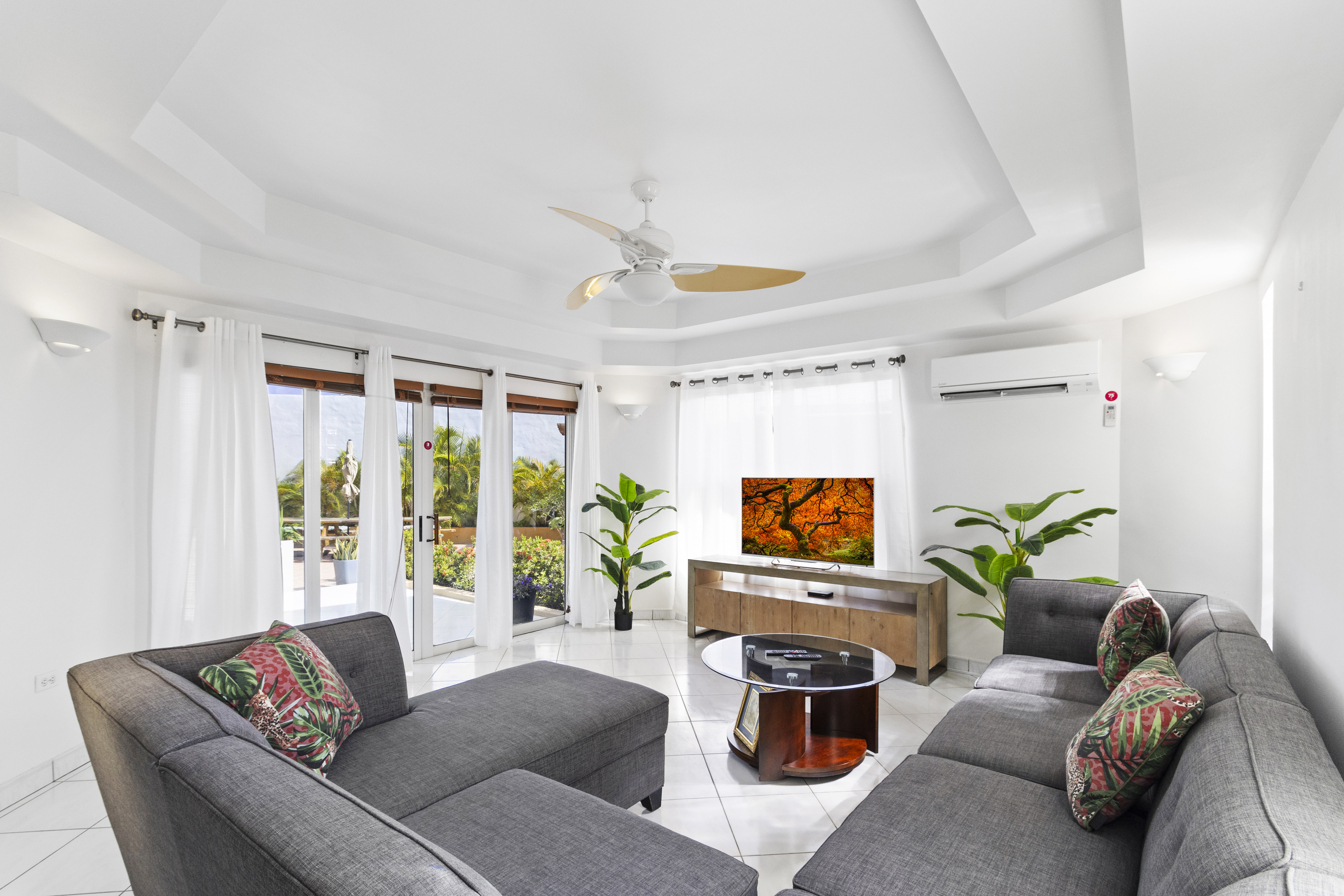 Glamorous Living area of house in Noord Aruba - Cozy sofas  - Large windows with Panoramic views - Smart TV and Netflix - Harmonious color scheme with pops of accent colors for visual interest