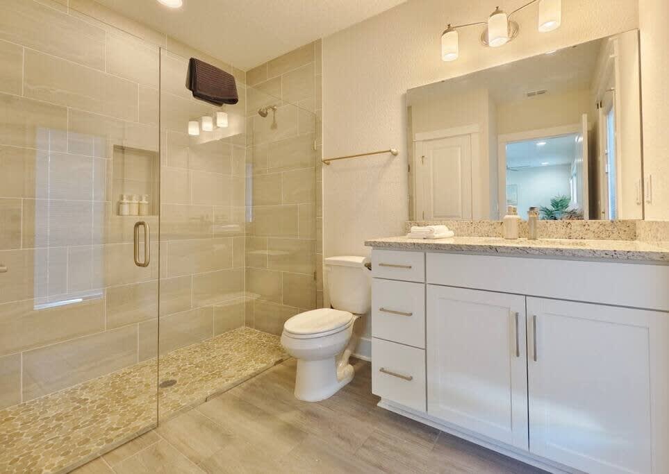 1st Floor: Full bathroom with walk-in shower and entrance to outside deck 