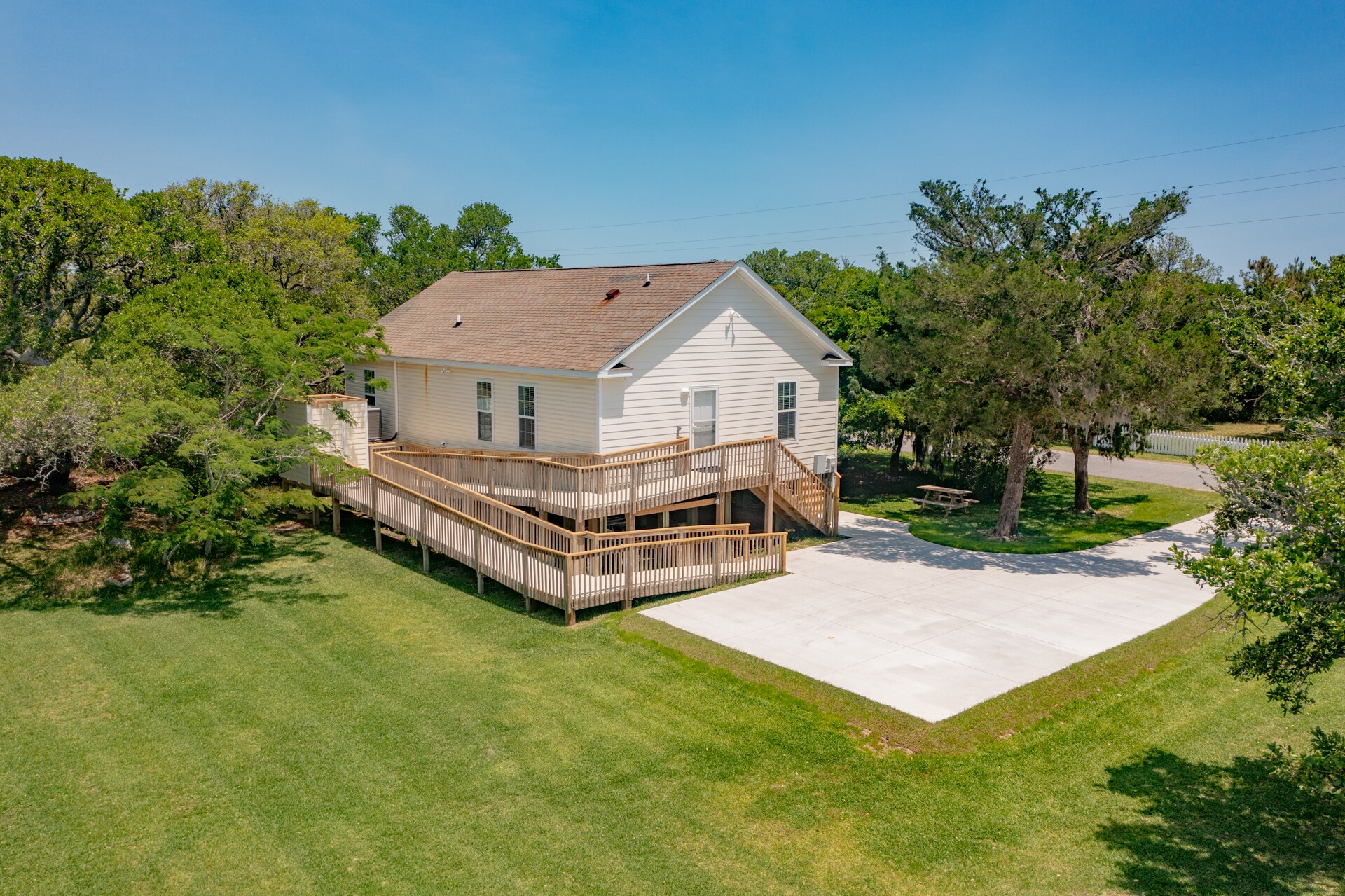 Exterior of Carrie's Place, featuring a spacious yard, driveway, handicap accessible ramp with one-level living!