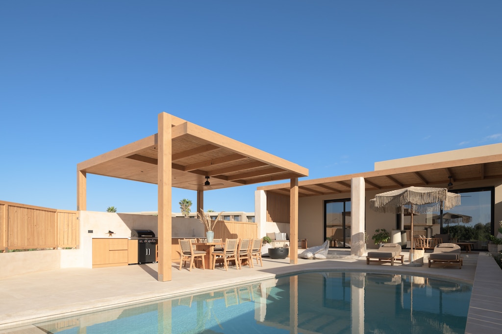 Outdoor settings, ideal for relaxed al fresco dining by the breathtaking pool.  
