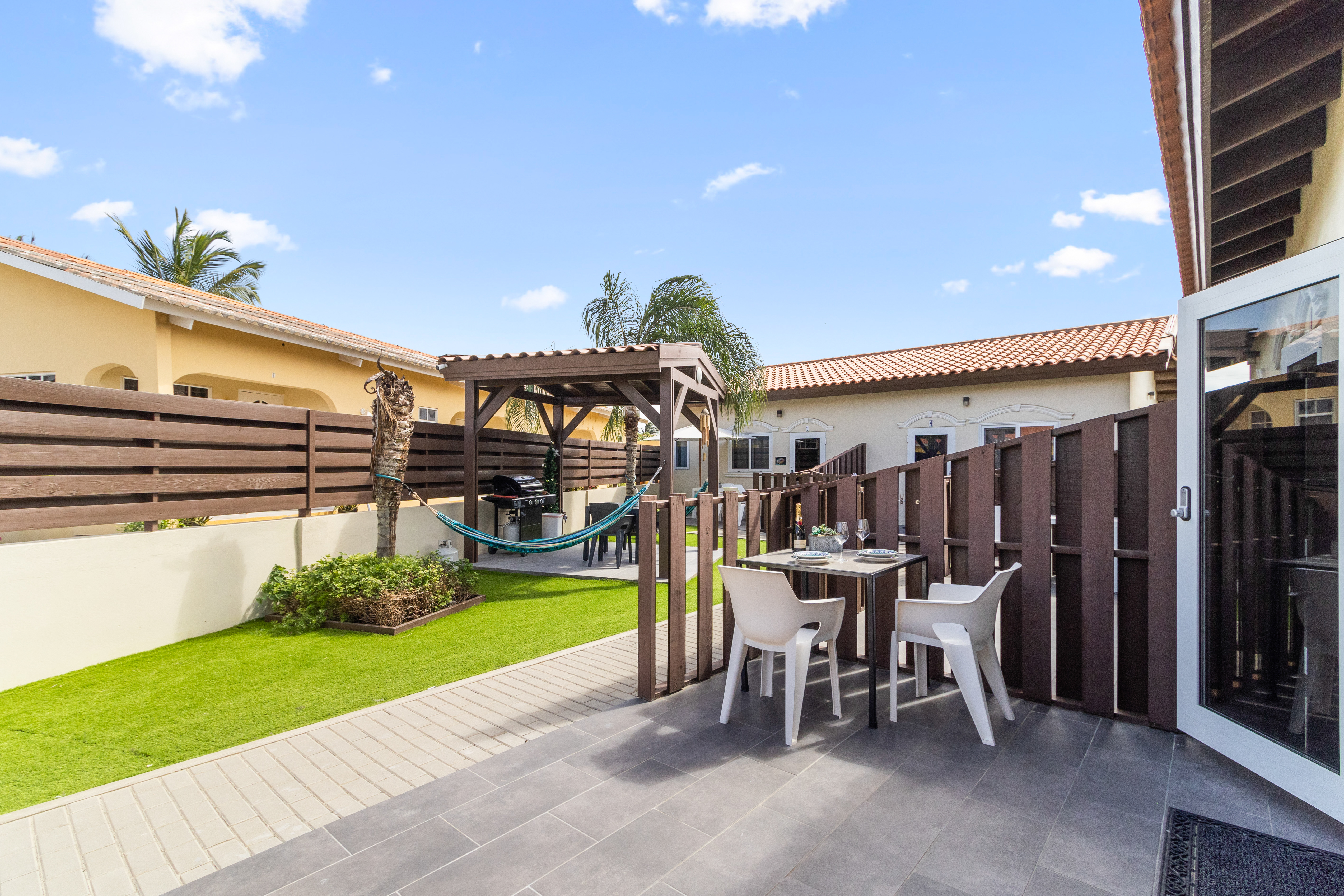 Fabulous Outdoor patio of the apartment in Noord, Aruba - Beautiful pool facing sitting area - Elite sitting in soul enhancing environment  - Mesmerizing pool views - Majestic decored space - Refreshing Environment