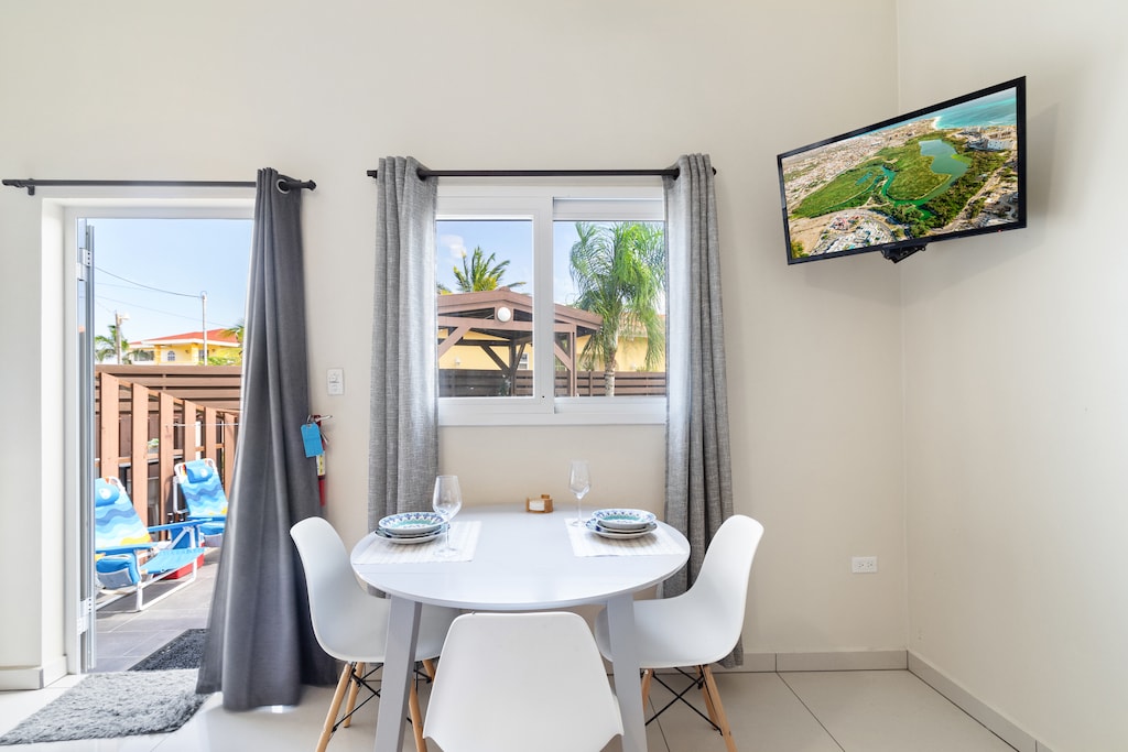 Charming Dining Area of the Apartment in Noord - 2 Persons Dining - Quality materials, such as a sleek dining table and comfortable chairs - Smart TV and Netflix - Modern Design