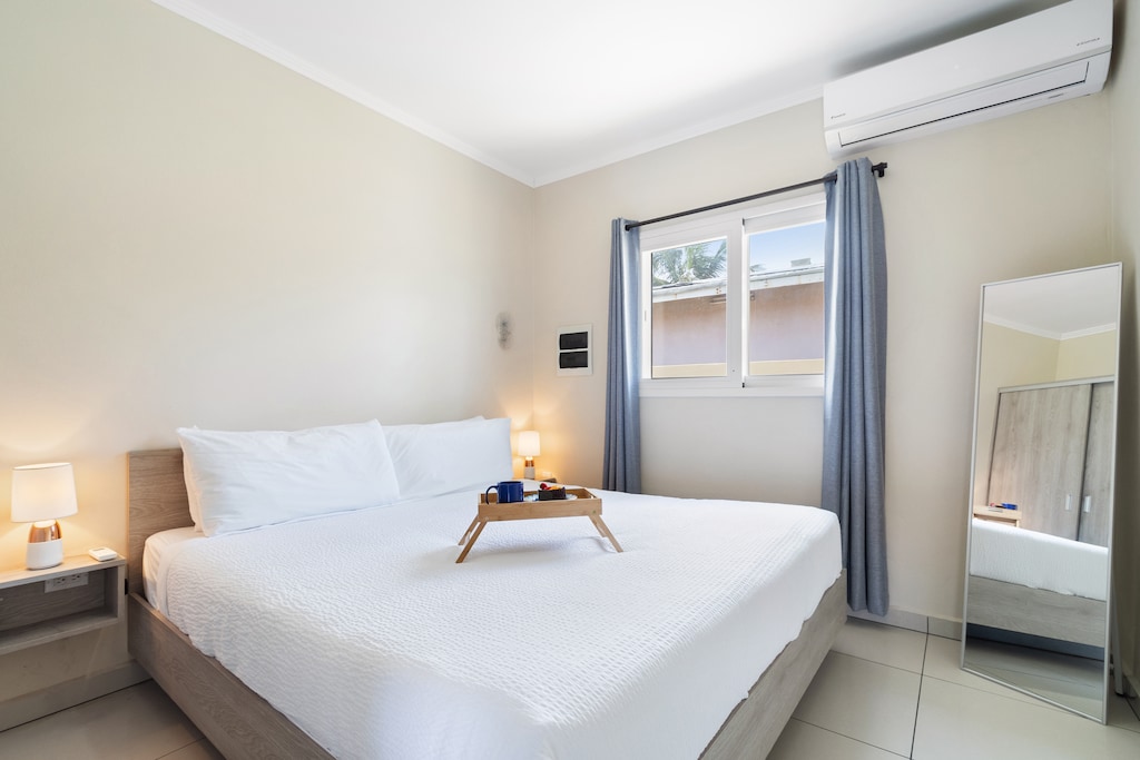 Fanciful Bedroom of the Apartment in Noord Aruba - Cozy retreat with a plush bed, perfect for relaxation - Smart TV and Netflix - Smart use of space with efficient storage solutions - Luxurious bedding for a restful night's sleep