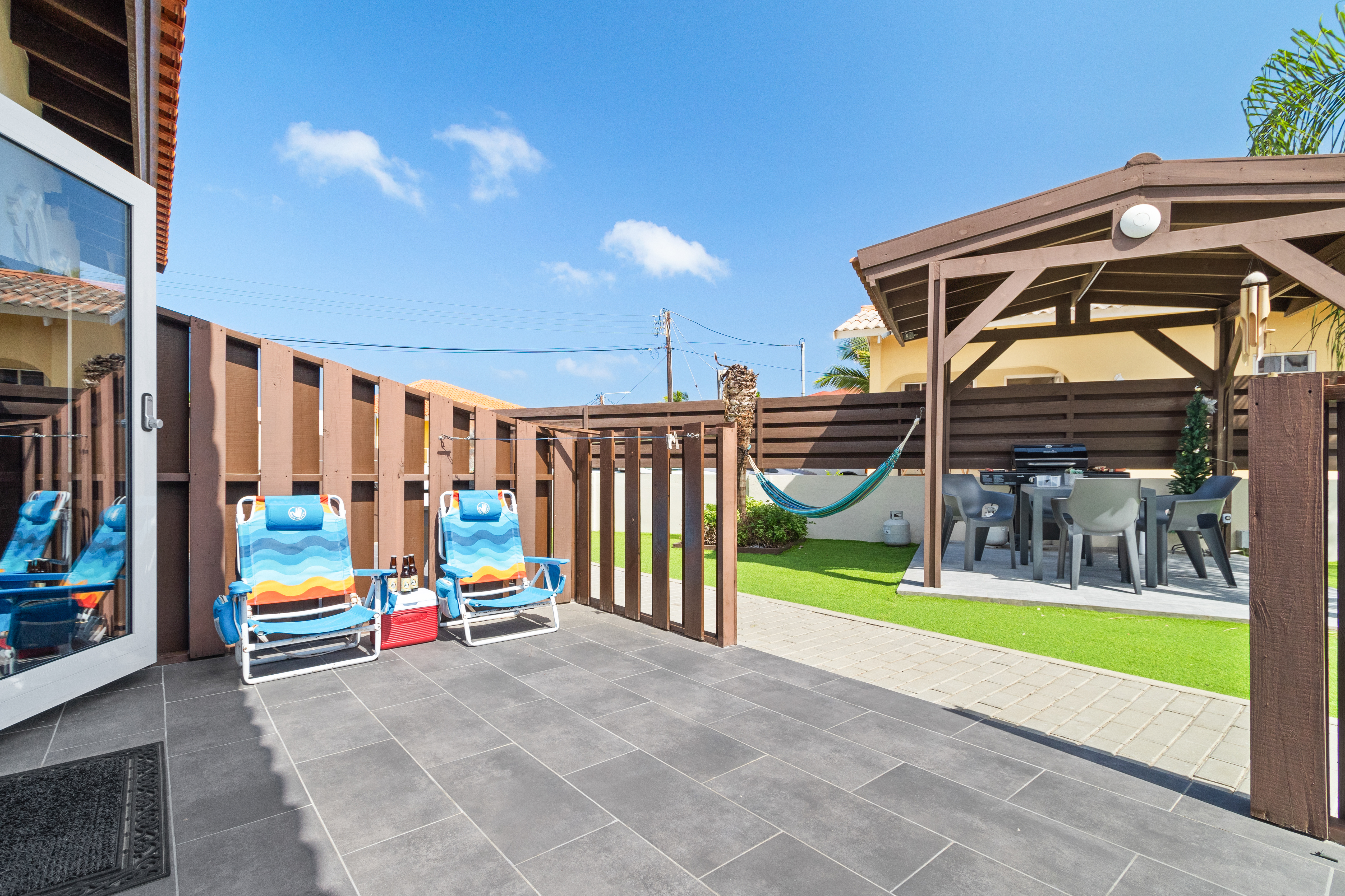 Outside Patio Area of the Apartment in Noord Aruba - Embrace a relaxed atmosphere in the great outdoors - Access to Pool Area - Attractive patio furniture and decor