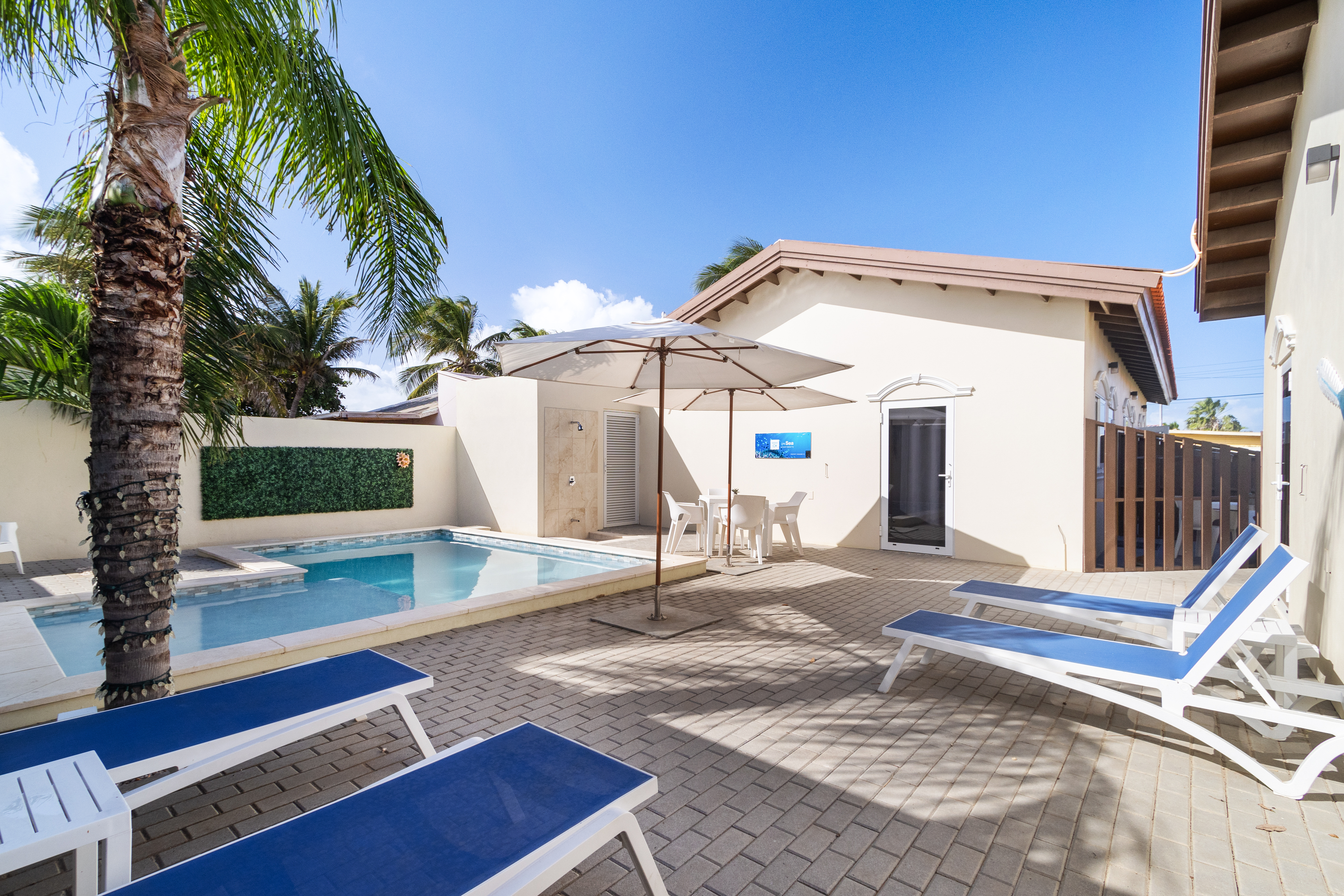 Relax and unwind in our shared pool area, complete with comfortable lounge chairs. Enjoy soaking up the sun and taking refreshing dips in the sparkling waters.