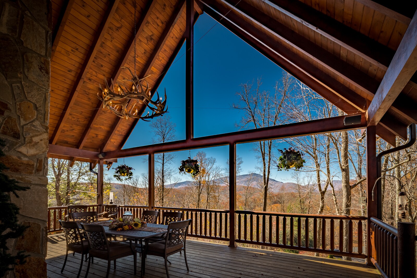 Long Range Mountain Views from Covered Porch with Custom Antler Chandelier and Outdoor Dining