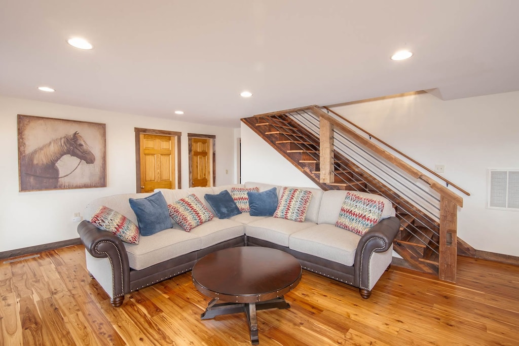 Den on Middle Level with Sectional Sofa and Wood Floors