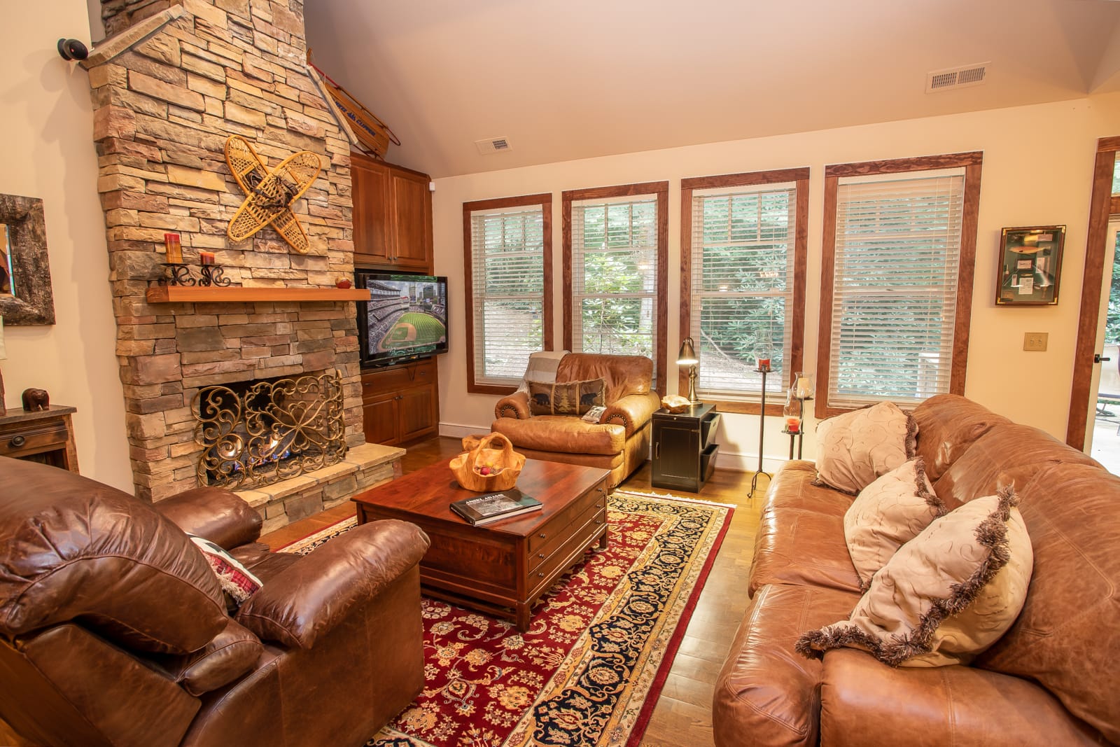 Great Room with Floor-to-Ceiling Stone Gas Log Fireplace and HD Smart TV