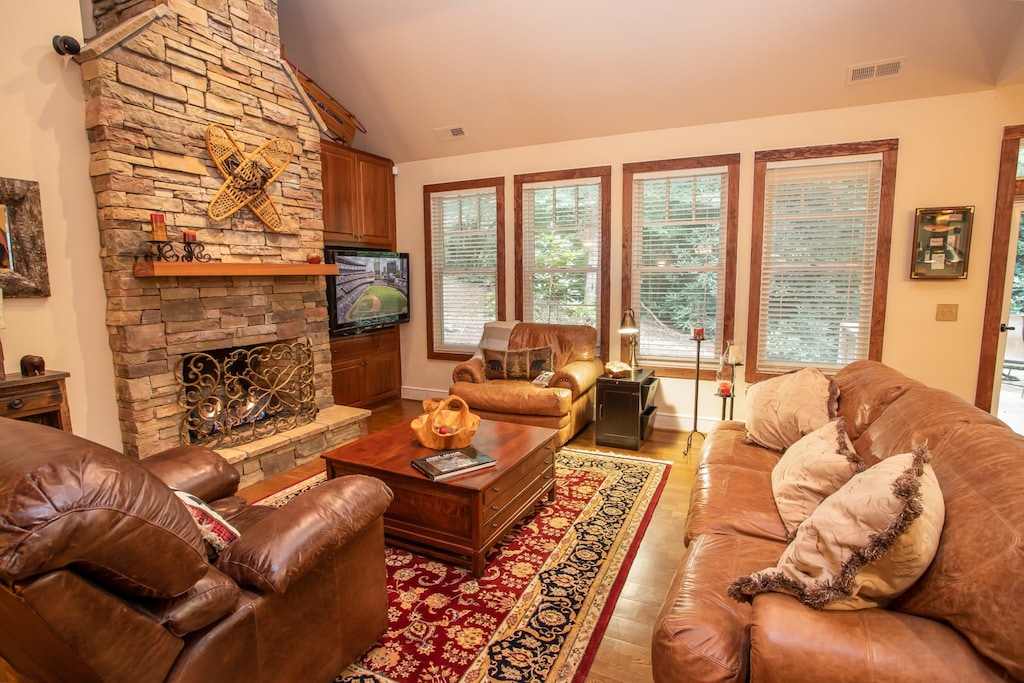 Great Room with Floor-to-Ceiling Stone Gas Log Fireplace and HD Smart TV