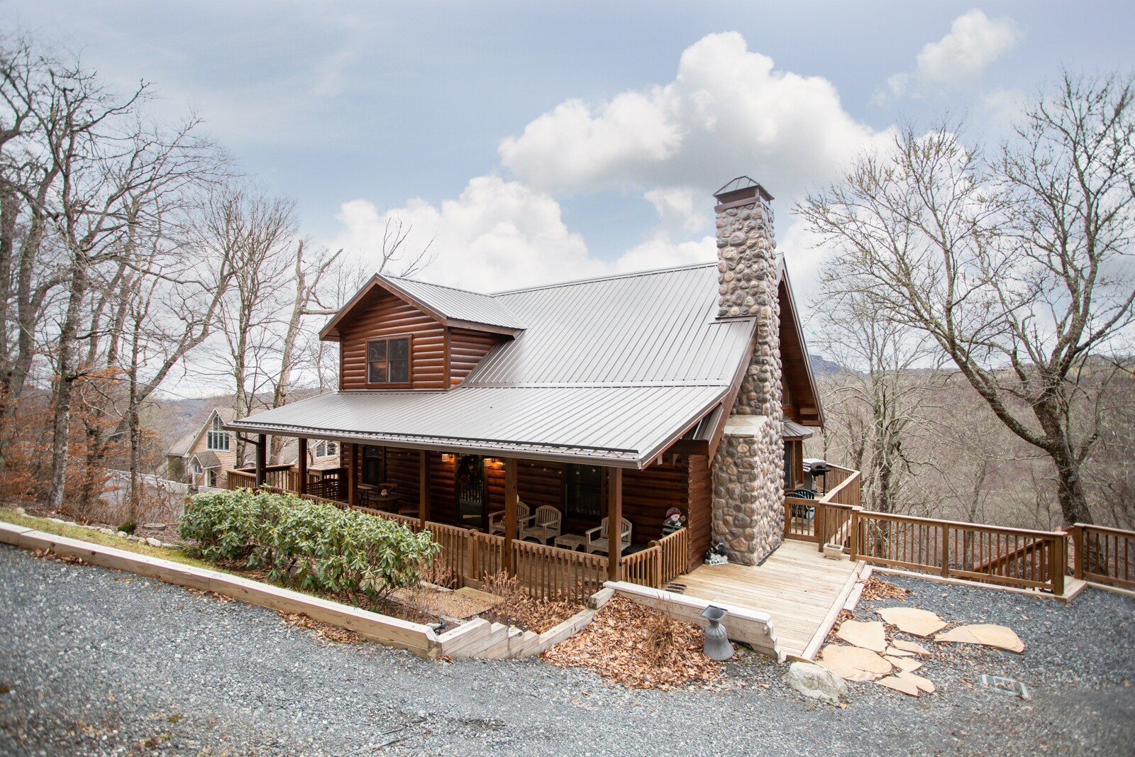 Sugar Bear is a Charming Log Cabin with Standing Seam Metal Roof and River Rock Chimney