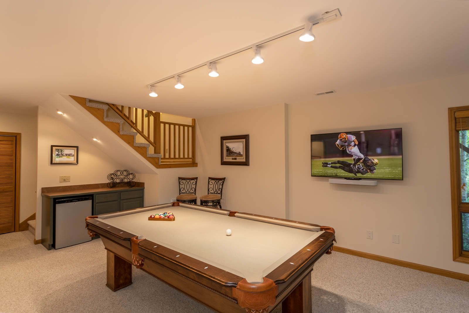 Pool Table, TV, and Mini Fridge  in the Lower Level Den