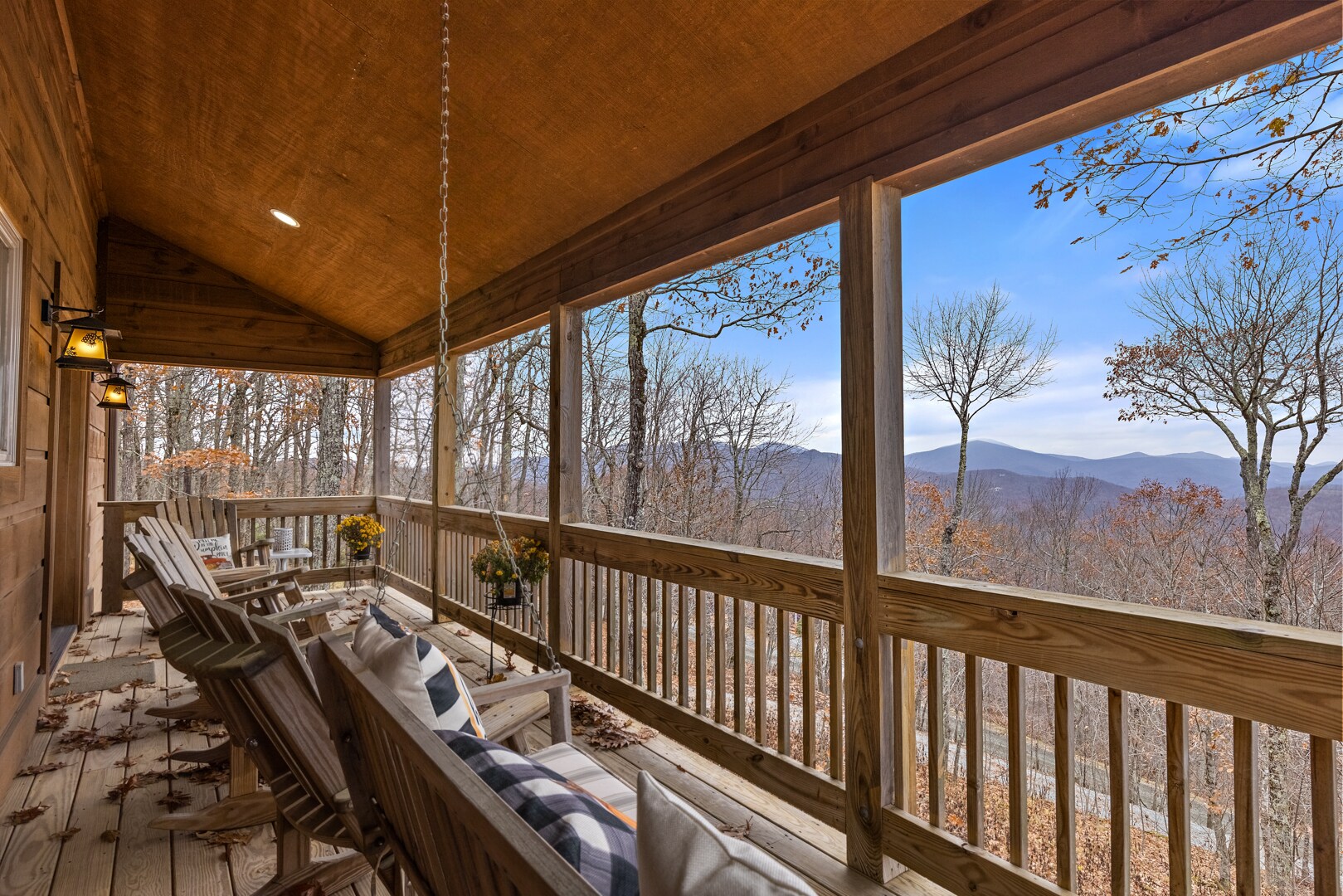 Porch Swing and Adirondack Style Seating on the Covered Deck Overlooking Long-Range Mountain Views