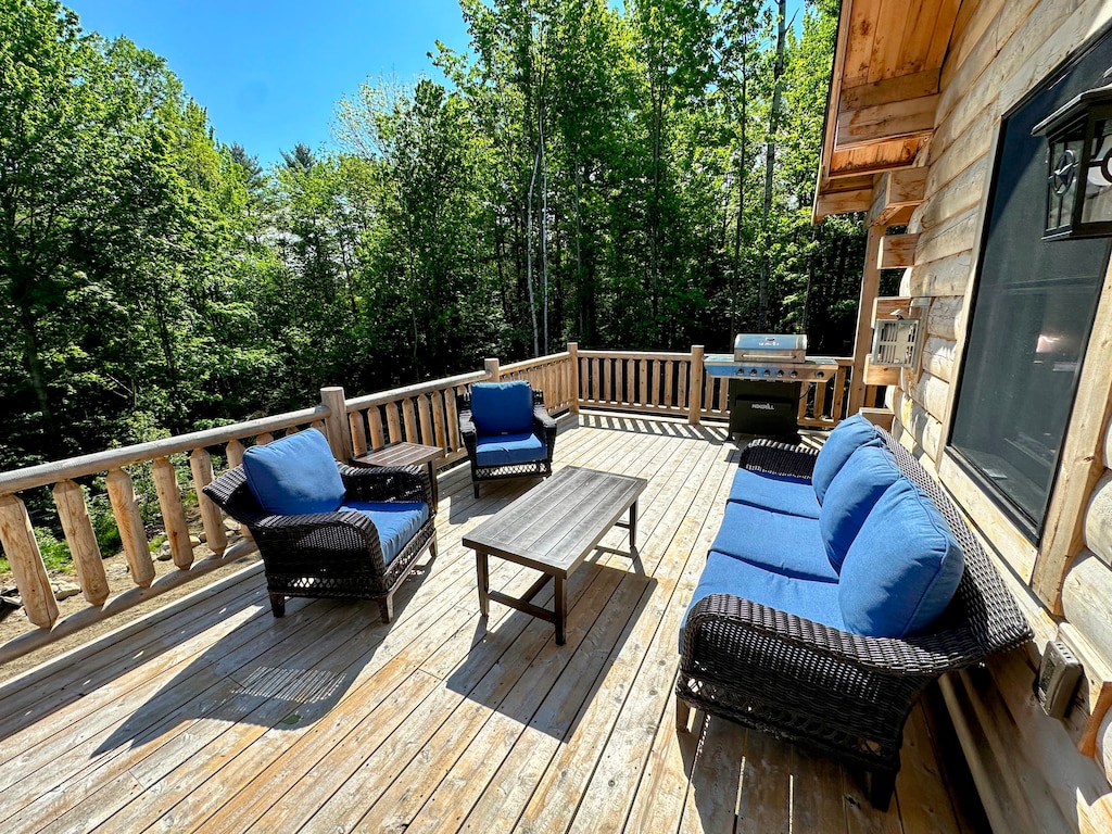 Deck with dining table, seating area, and grill