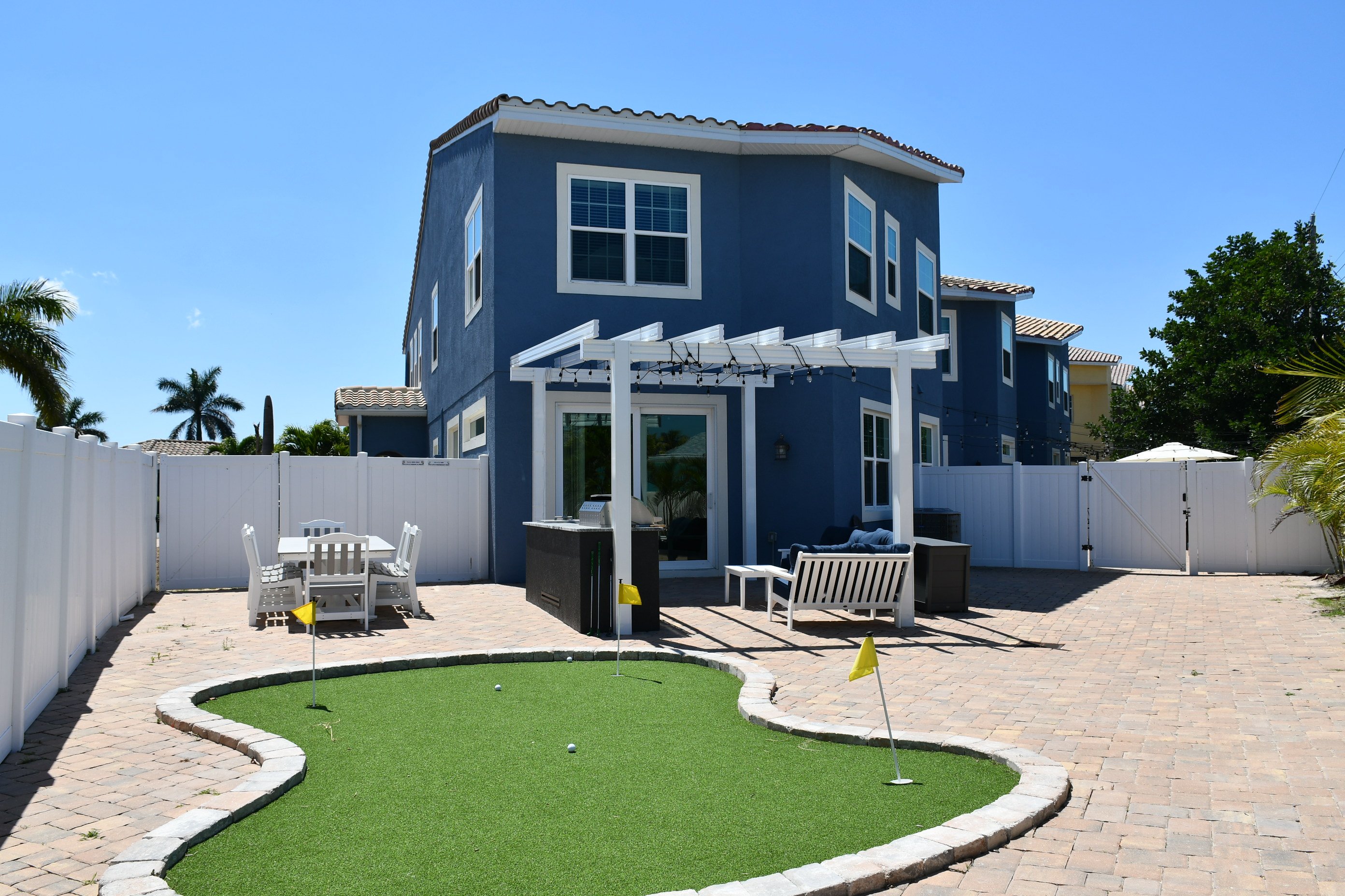 Patio entertaining area with brand new outdoor kitchen, dining area & putting green!