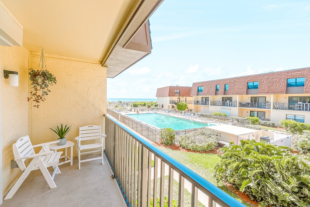 Relaxing balcony with seating, offering stunning ocean views and fresh sea breeze.