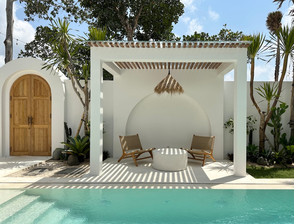 An outdoor lounge with two chairs and a terrazzo coffee table