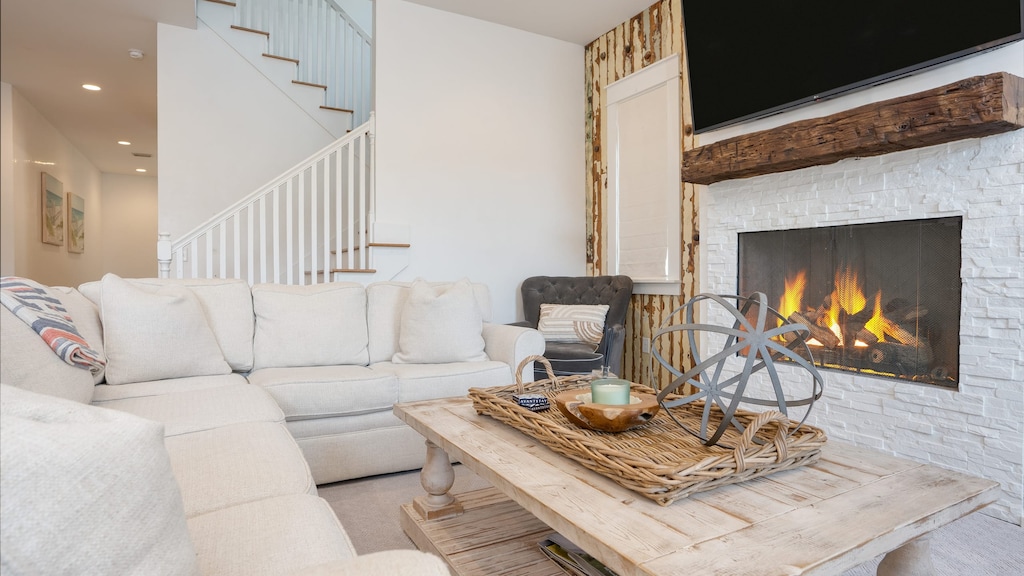 Cozy living area feature a plush sectional, fireplace, and large flat-screen TV.