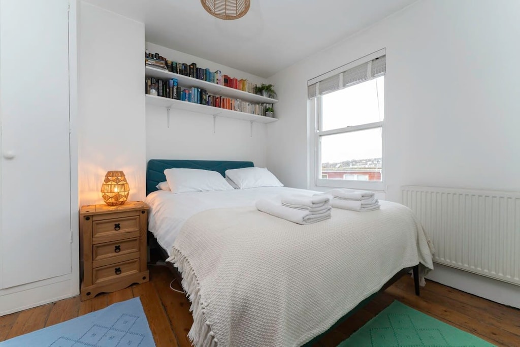 King size bed in bedroom 2 made up with fresh hotel linen and towels for all guests