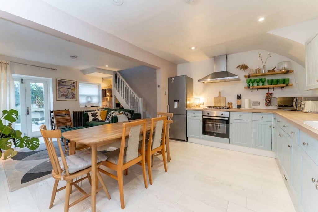 Modern kitchen that's fully equipped and has a dining table so you can make and share a meal together