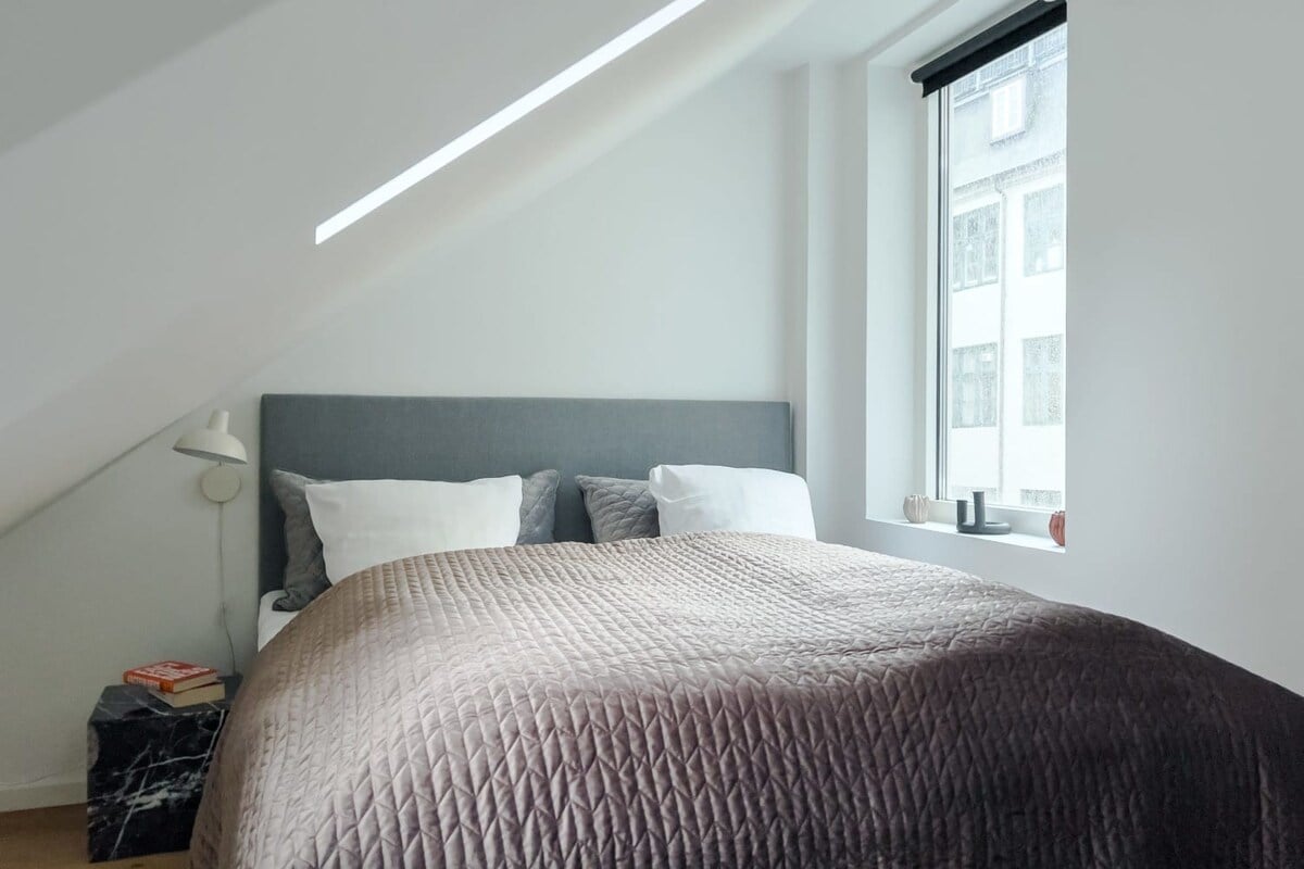 The big window and slanted window allow plenty of natural light to flood into the room, making it bright and airy. However, if you need a little extra shut-eye, the black-out curtains will ensure that you get a restful night's sleep.