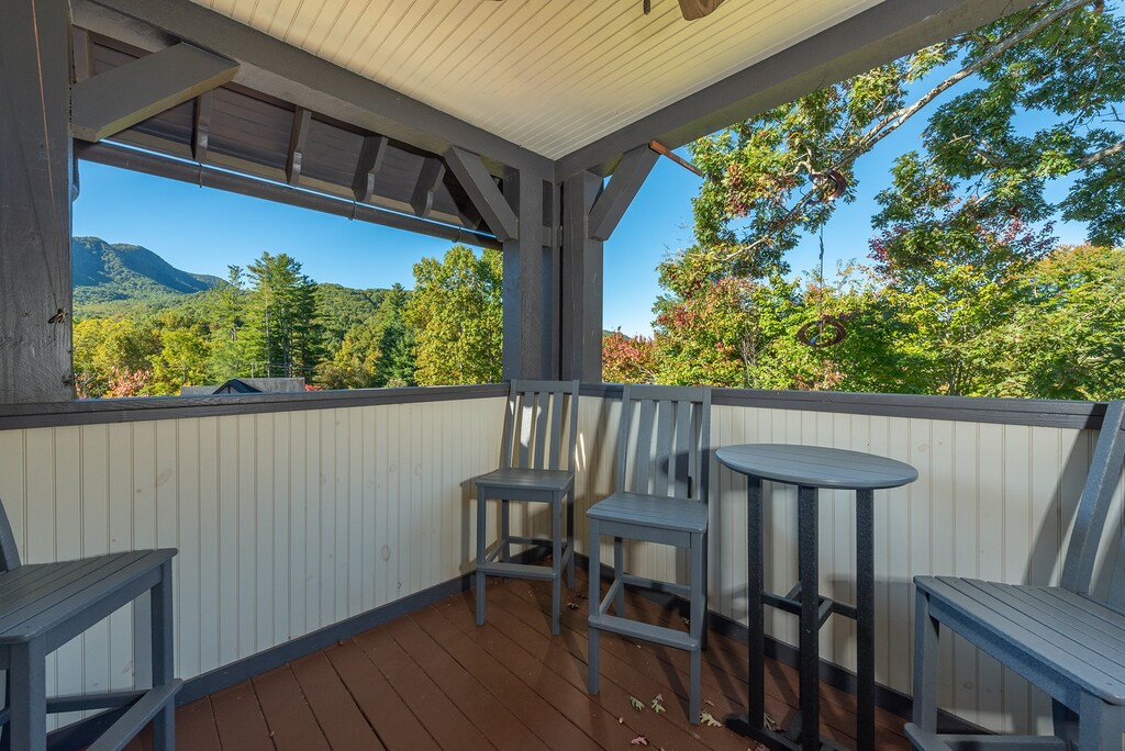 Upper-level covered porch with various options for seating & beautiful mountain views!