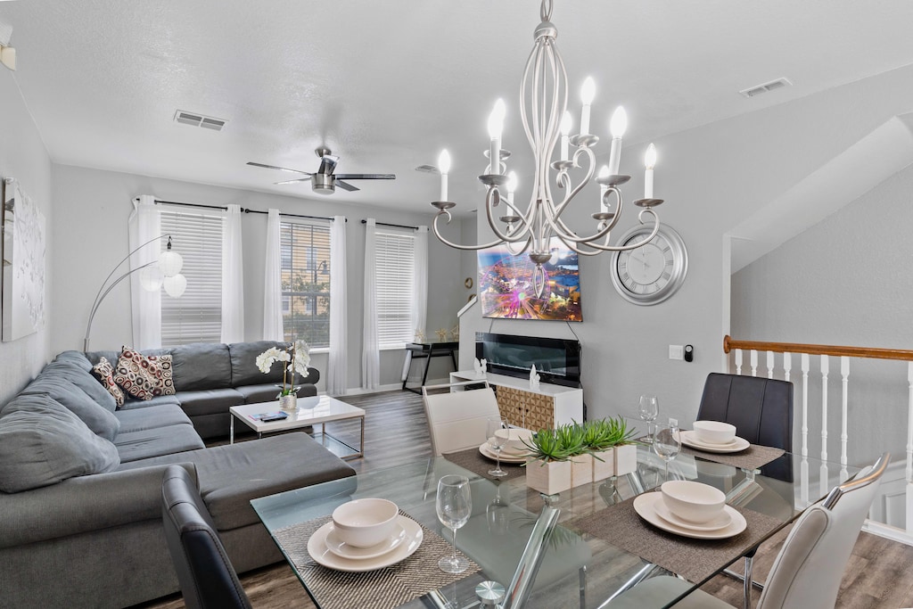 - Chic dining area of the townhouse in Orlando - Featuring a stylish table and contemporary seating - Thoughtful lighting fixtures creating an intimate and inviting atmosphere - 6 persons dining under a majestic chandelier