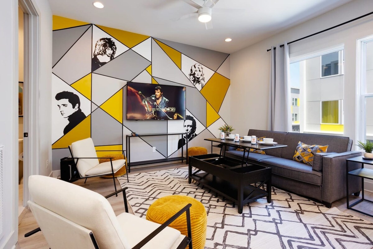 Imagine lounging with your closest friends in this striking Nashville living room, crafted specifically with bachelorette or family vacations in mind. From the captivating geometric wall art adorned with musical icons to the cozy, chic seating, each corner of this space celebrates the spirit of Music City. Whether you're watching a concert on the large flat-screen TV or planning your city tour around the stylish dining area, this luxury vacation rental wraps you in the vibrant pulse of Nashville. Ideal for any group getaway, it promises an unforgettable escape in the heart of Music City's melody.

Book your stay at Misfit Homes now! 🎶✨