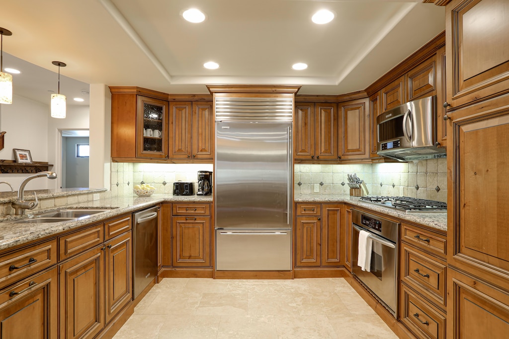 This well-appointed kitchen boasts chef-grade appliances, ample counter space, top-of-the-line cookware and cutlery, a spacious double sink