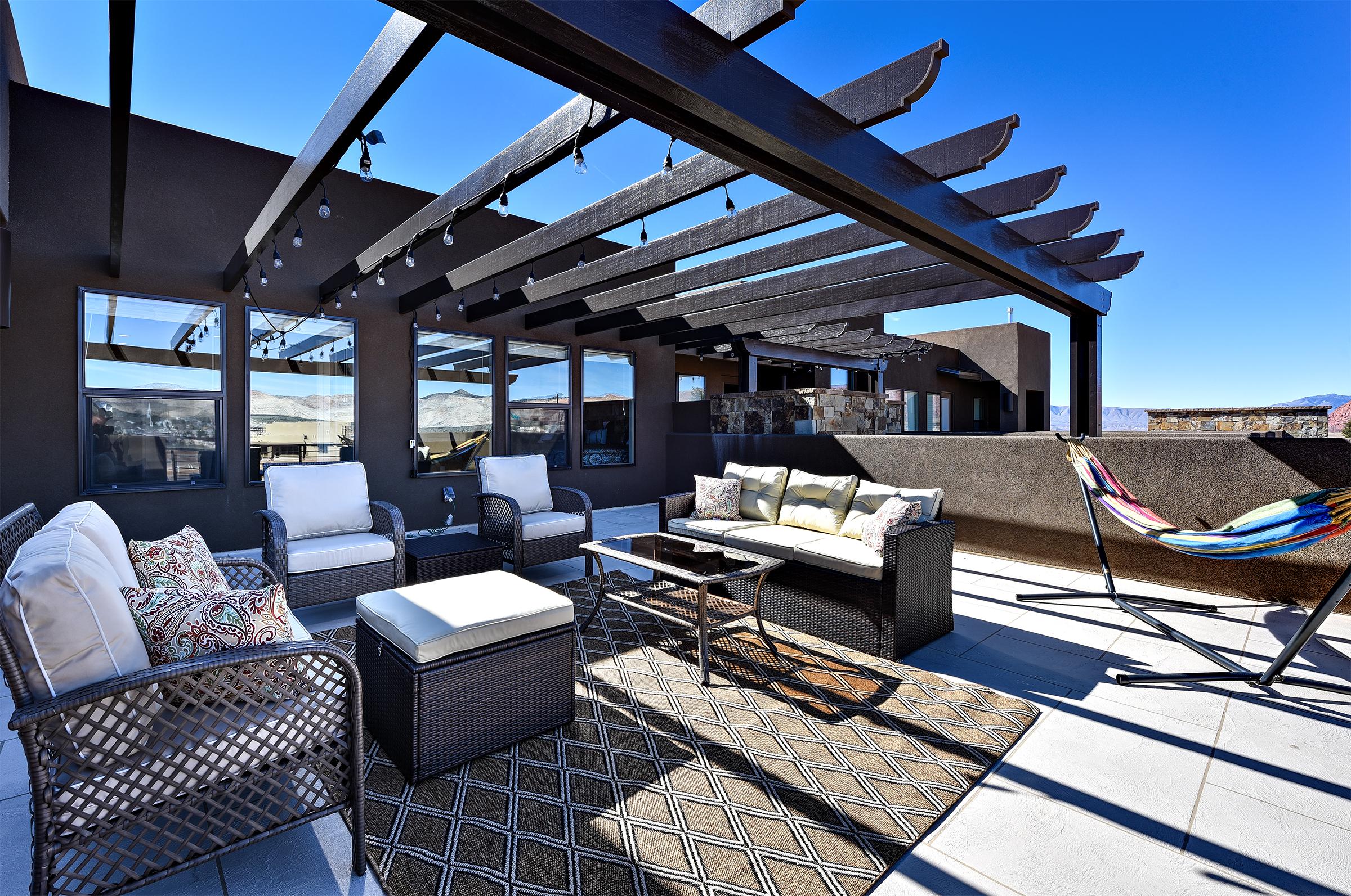 Enjoy the weather under the pergola while sitting in our comfortable patio furniture.