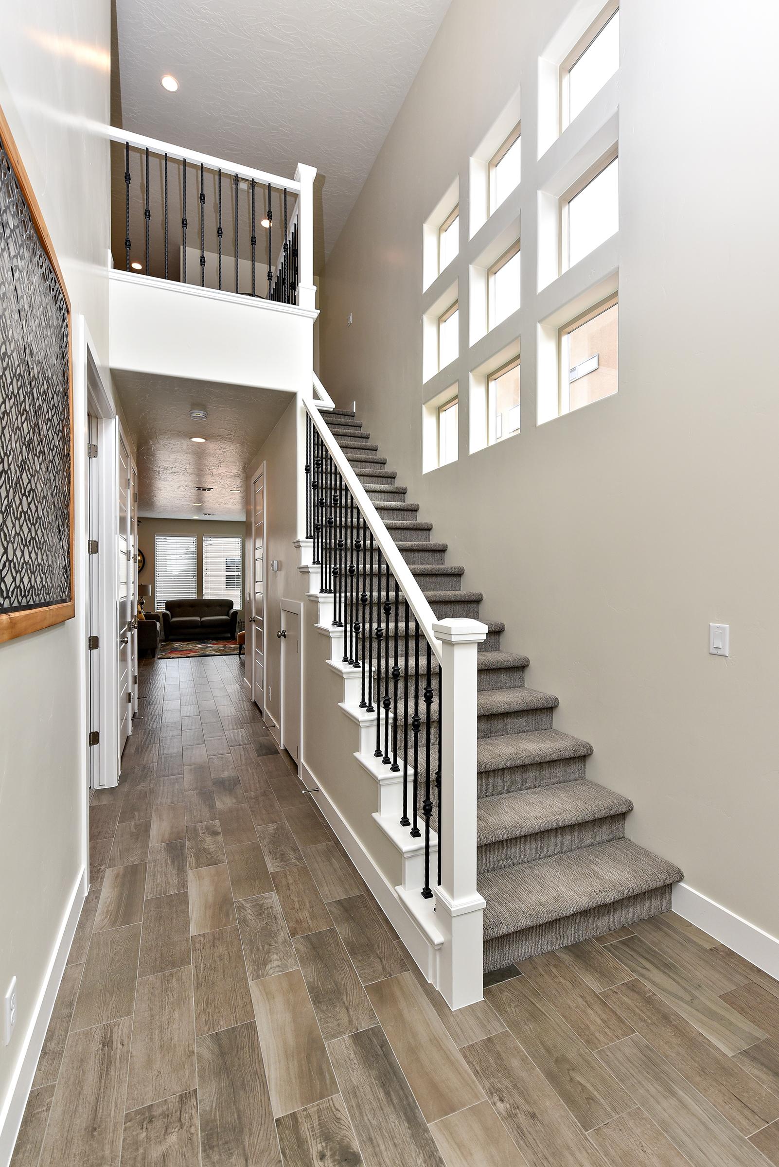 The Main Hallway leads to the Master Bedroom, Kitchen, Dining Room, and Living Room.  The Stairway leads to the Upstairs Bedrooms and Family Room.