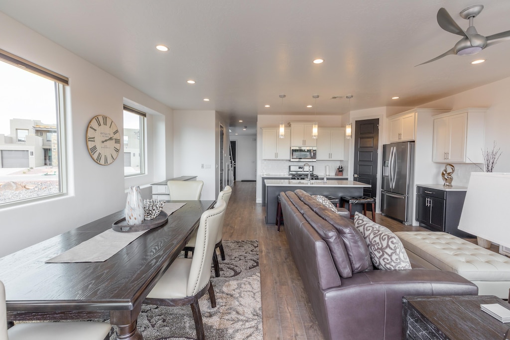 The Kitchen and Dining Table can accommodate 10 adults and is stocked with pots, pans, baking sheets, mixing bowls, plates, bowls, cups, silverware, and a collection of cooking utensils.