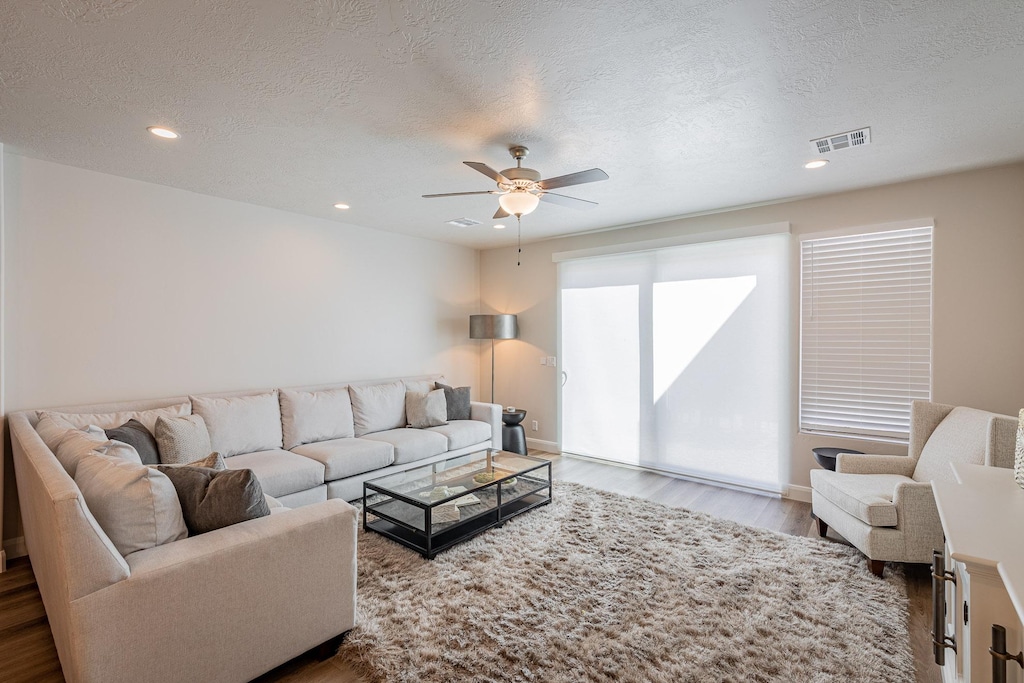 The living room is conveniently adjacent to the kitchen. There is also access to the back patio which has a BBQ grille suitable for all your favorite BBQ dishes.
