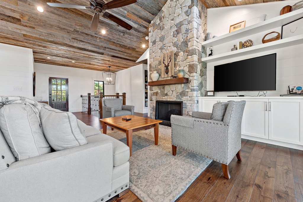 A cozy living area centered around a  fireplace, complemented by comfortable seating and large windows that flood the space with natural light.