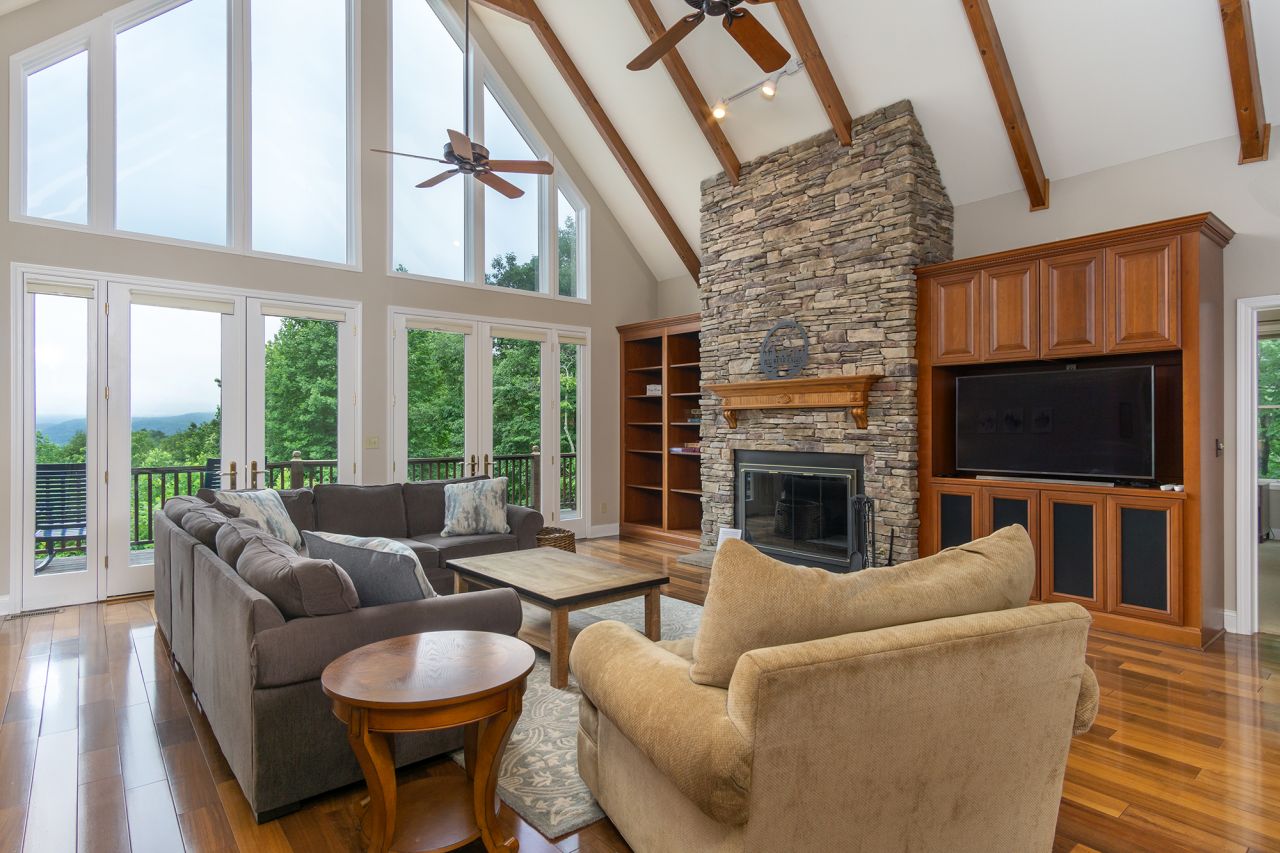 Gorgeous living room with 25ft high ceilings with exposed rafter floor-to-ceiling views at Big Bear Cabin!
