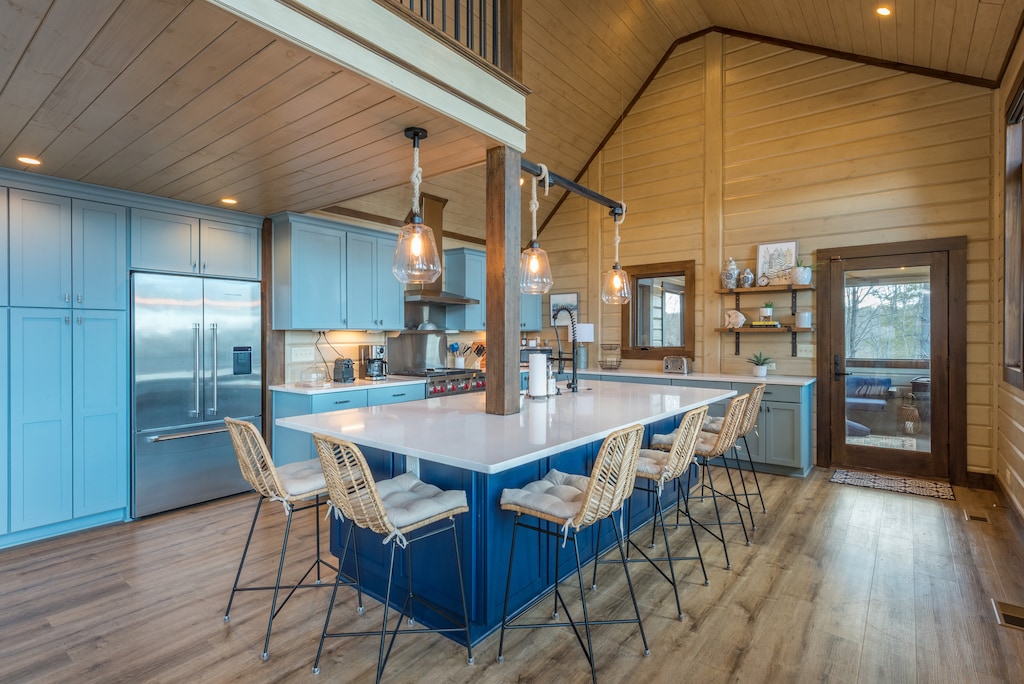 Gourmet kitchen with dishwasher, standard coffeemaker, and bar seating for 6.