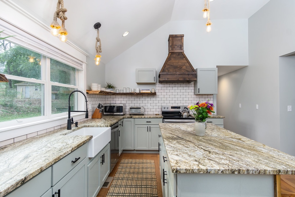 Kitchen complete with island with seating for 3, a dishwasher & a standard Drip coffeemaker.