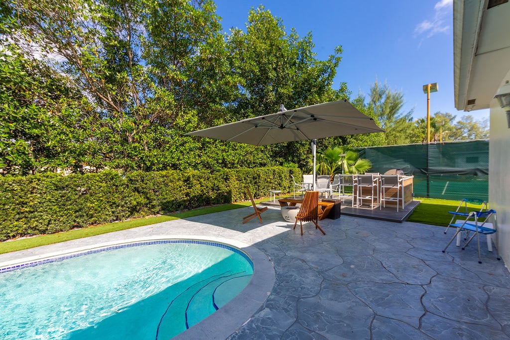 Terrace and fire pit next to the sparkling heated pool.