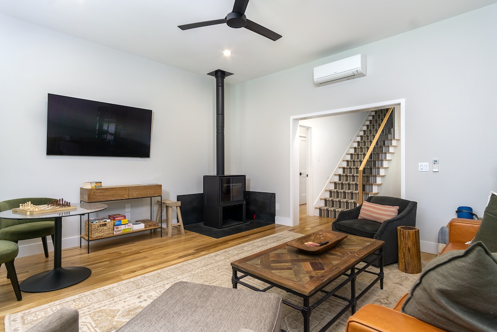 Stay cozy around the wood stove in the living room while streaming your favorites on the 65" Smart TV.