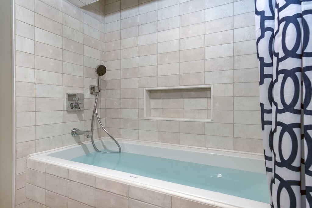 Bathroom with shower & tub combo.